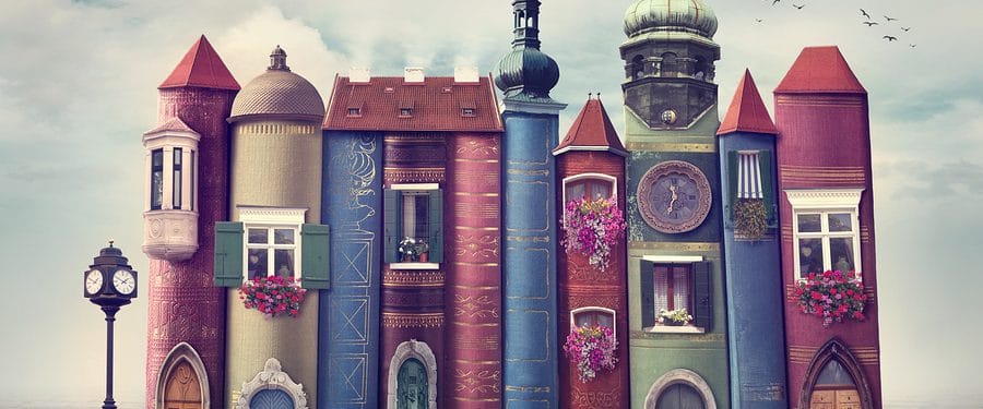 Colorful buildings designed to resemble stacked books, featuring intricate details and decorative elements, set against a cloudy sky.